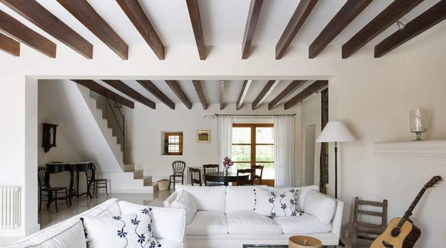 Illumination of wooden beams in the living room.  The use of decorative beams on the ceiling in interior design.  Modern designs: loft, hi-tech