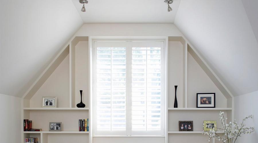 A table by the window with cabinets on the sides.  Table by the window in the interior of a children's room.  Example of wardrobes in a bedroom